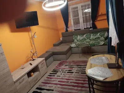 a small living room with a couch and a table at Uroczy Apartament in Kraków