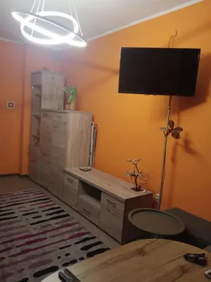 a room with a desk and a television on a wall at Uroczy Apartament in Kraków
