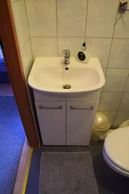 a bathroom with a white sink and a toilet at Noclegi Viktor in Kalwaria Zebrzydowska