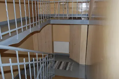 a staircase in a building with white railings at Noclegi Viktor in Kalwaria Zebrzydowska