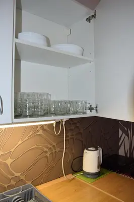 a kitchen with white cabinets and a toaster on a counter at Noclegi Viktor in Kalwaria Zebrzydowska