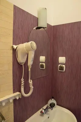 a hair dryer is attached to the wall of a bathroom at Noclegi Viktor in Kalwaria Zebrzydowska