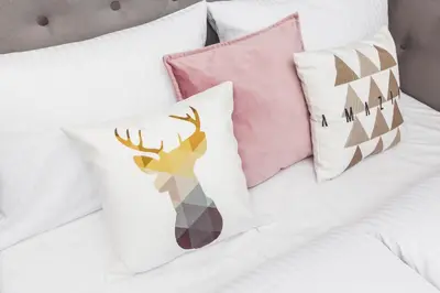 a bed with four pillows and a deer on it at Traveler's Best Choice - Old Town Guesthouse - by Upstairs in Kraków