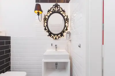 a bathroom with a white sink and a mirror at Traveler's Best Choice - Old Town Guesthouse - by Upstairs in Kraków