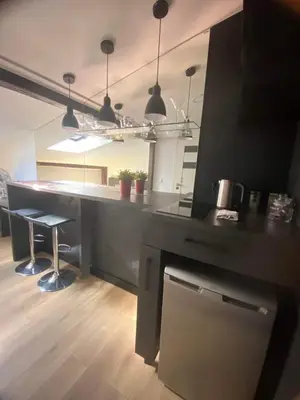 a kitchen with a counter and a table with chairs at Jack Apartment in Old Town in Kraków