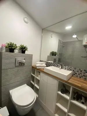 a bathroom with a toilet and a sink and a mirror at Jack Apartment in Old Town in Kraków