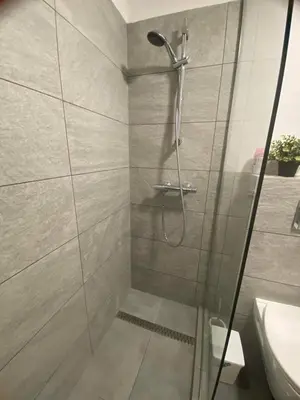 a shower with a glass door in a bathroom at Jack Apartment in Old Town in Kraków