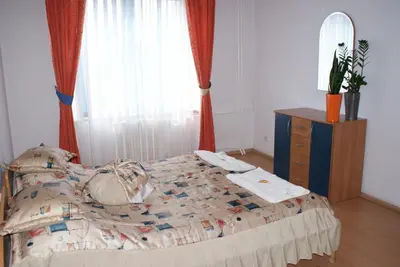 a bedroom with a bed with a dresser and a mirror at Hotel Monttis in Sucha Beskidzka
