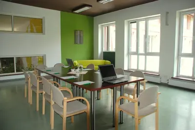 a conference room with a table and chairs and a laptop at Hotel Monttis in Sucha Beskidzka