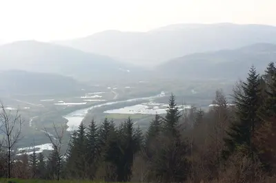 a view of a river in a valley with mountains at Hotel Monttis in Sucha Beskidzka
