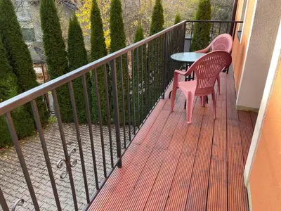 a bedroom with a bed and a tv and a table at Apartamenty Przy Parku in Rabka