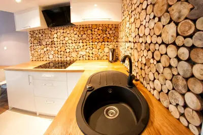 a kitchen with a sink and a bunch of logs at Kasia&Lukasz Apartments in Kraków