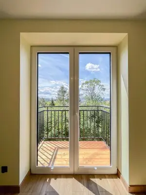 a sliding glass door with a view of a balcony at Apartament Ptasi Śpiew in Rabka