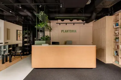 an office with a reception desk with plants at PLANTONIA Aparthotel in Kraków