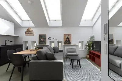 a living room with a couch and a table at PLANTONIA Aparthotel in Kraków