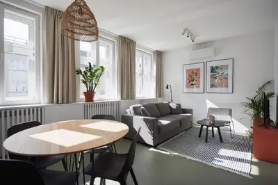 a living room with a couch and a table at PLANTONIA Aparthotel in Kraków
