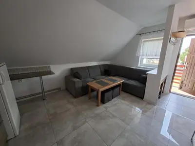 a living room with a couch and a table at Mieszkanie A Łowiczki in Zator