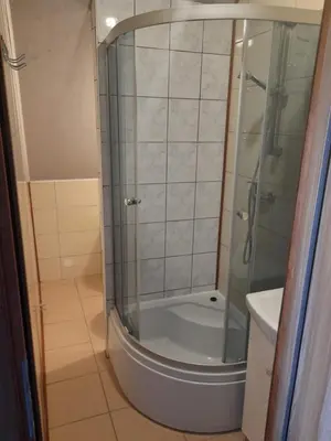 a bathroom with a shower and a toilet and a sink at Mieszkanie A Łowiczki in Zator
