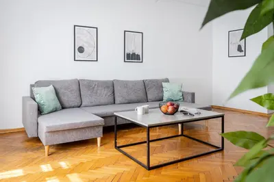 a living room with a couch and a coffee table at Brzozowa Apartments by Hostly in Kraków