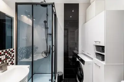 a bathroom with a shower and a washing machine at Brzozowa Apartments by Hostly in Kraków