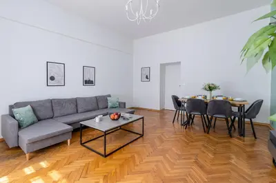 a living room with a couch and a table at Brzozowa Apartments by Hostly in Kraków