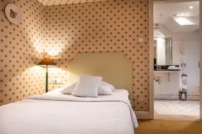 a bedroom with a bed and a wall with polka dots at Hotel Gródek in Kraków