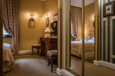 a hotel room with a bed and a mirror at Hotel Gródek in Kraków