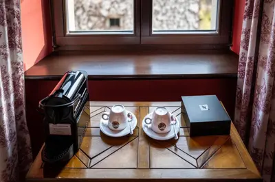 a table with two teapots and a laptop on it at Hotel Gródek in Kraków