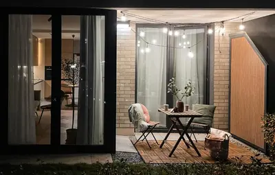 a patio with a table and a chair and a house at #1 OLIVE Apartment City Center FREE GARAGE in Kraków