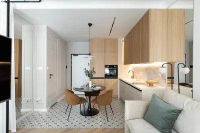 a kitchen and living room with a table and a couch at #1 OLIVE Apartment City Center FREE GARAGE in Kraków