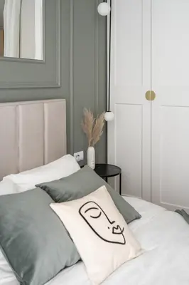 a bed with a pillow with a face on it at #1 OLIVE Apartment City Center FREE GARAGE in Kraków