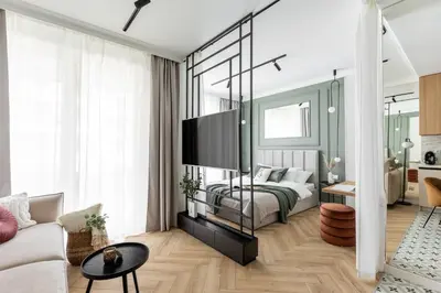 a bedroom with a bed and a living room at #1 OLIVE Apartment City Center FREE GARAGE in Kraków