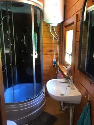 a bathroom with a sink and a shower and a toilet at Domek letniskowy Biedówka in Limanowa
