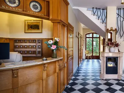 a bathroom with a sink and a toilet and a mirror at Hotel Maltański in Kraków
