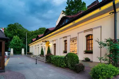 a dining room with a table and chairs at Hotel Maltański in Kraków
