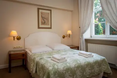 a bedroom with a bed with towels on it at Dom Pugetów in Kraków