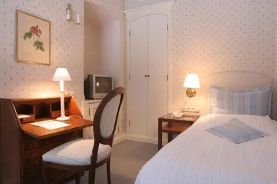 a bedroom with a desk and a bed and a desk and chair at Dom Pugetów in Kraków