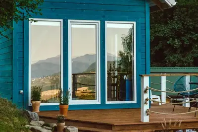 a blue house with a view of the mountains at RESETówka nr 3 - domek na odludziu z mega widokami - Lazurowe Love in Jaszczurowa