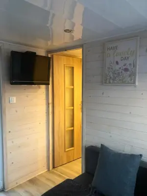 a room with a door and a tv on a wall at Słoneczne ranczo Zator Energylandia in Zator