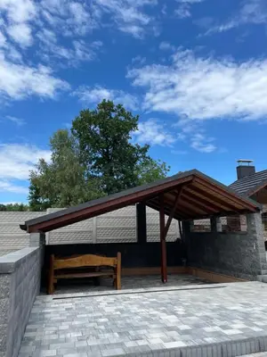 a pavilion with a wooden bench on a patio at Słoneczne ranczo Zator Energylandia in Zator