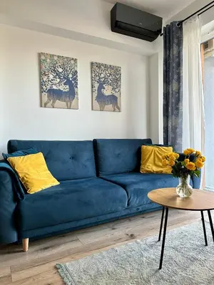 a blue couch in a living room with a table at Flow 8 by Housine in Zator