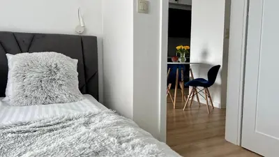 a bedroom with a bed and a table and a chair at Chill & Fun 22 by Housine in Zator