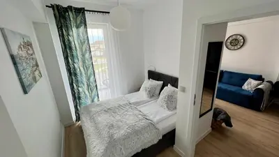 a small bedroom with a bed and a window at Chill & Fun 22 by Housine in Zator