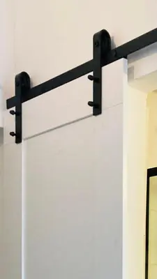 a white wall with a black bracket on it at Supreme Apartment in the City Center in Kraków