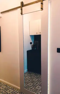 a mirror hanging on a wall in a room at Supreme Apartment in the City Center in Kraków