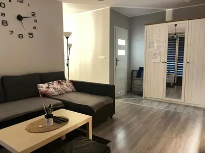 a living room with a couch and a table at Apartament Blondynka Miasto Soli Bochnia in Bochnia