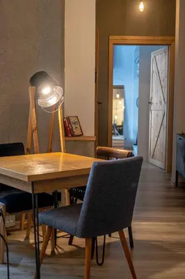 a dining room table with chairs and a lamp at Orzeszkowej PREMIUM Apartament in Kraków