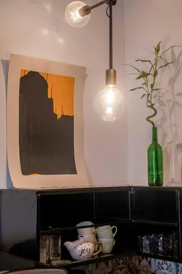 a room with a picture and a vase and a lamp at Orzeszkowej PREMIUM Apartament in Kraków