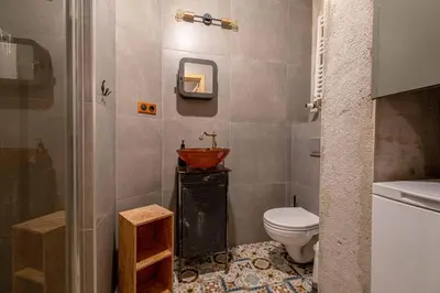 a bathroom with a sink and a toilet at Orzeszkowej PREMIUM Apartament in Kraków