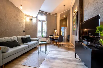 a living room with a couch and a tv at Orzeszkowej PREMIUM Apartament in Kraków